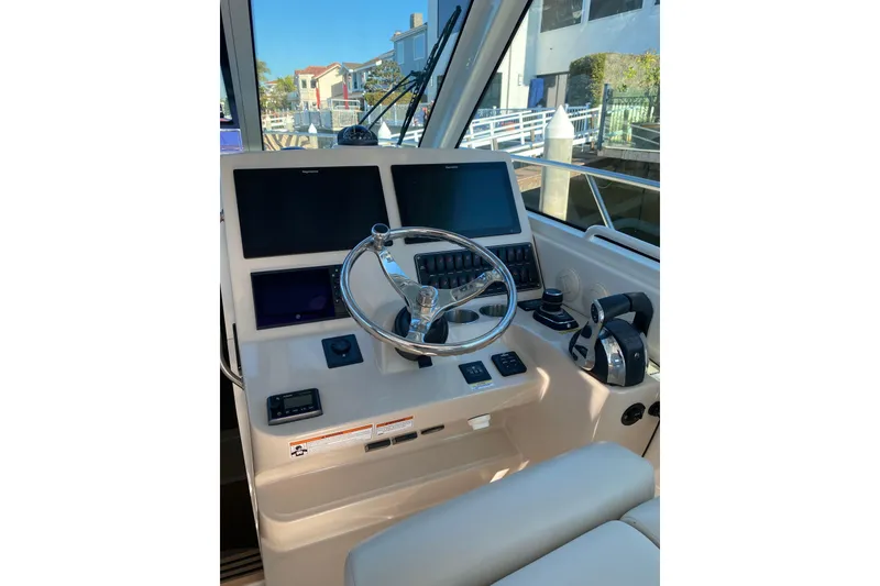 Slide: The Image of 2021 Boston Whaler 345 Conquest helm with modern controls and navigation screens. - 8
