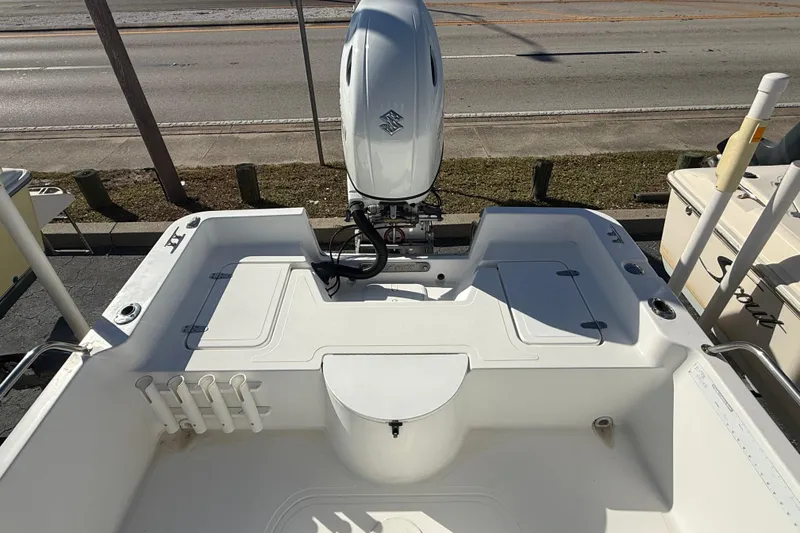 Slide: The Image of 2003 Sea Pro SV2100CC Bay Boat with outboard motor, spacious deck, and rod holders. - 10