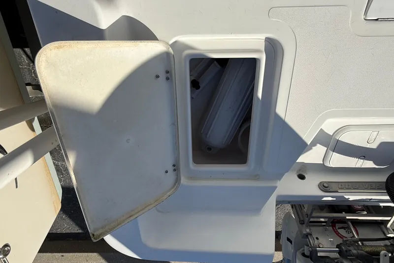 Slide: The Image of 2003 Sea Pro SV2100CC Bay Boat storage compartment with open lid, revealing interior. - 13