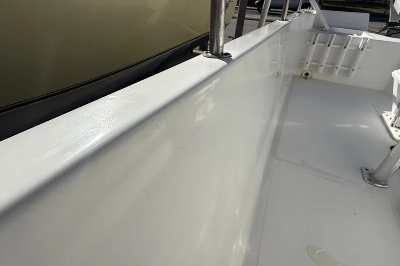 Slide: The Image of 2003 Sea Pro SV2100CC Bay Boat interior, showcasing clean white deck and railing. - 16