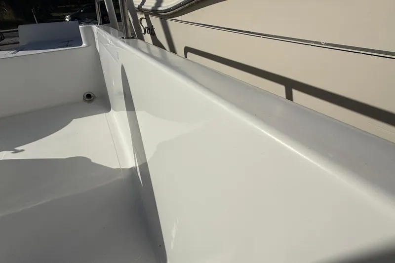Slide: The Image of 2003 Sea Pro SV2100CC Bay Boat interior with clean white deck and railing. - 17
