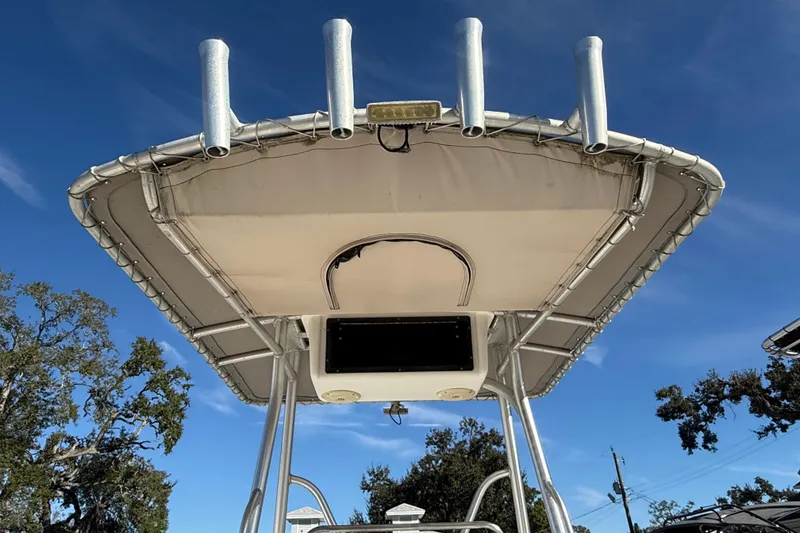 Slide: The Image of 2003 Sea Pro SV2100CC Bay Boat T-top with rod holders against blue sky. - 18