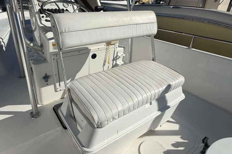 Slide: The Image of 2003 Sea Pro SV2100CC Bay Boat interior with white cushioned seating and steering console. - 19