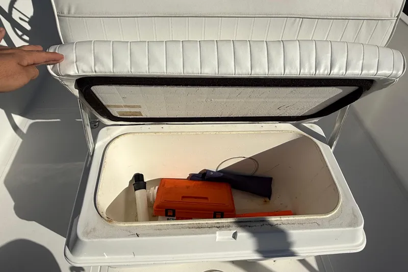 Slide: The Image of Open storage compartment on 2003 Sea Pro SV2100CC Bay Boat with safety equipment inside. - 20