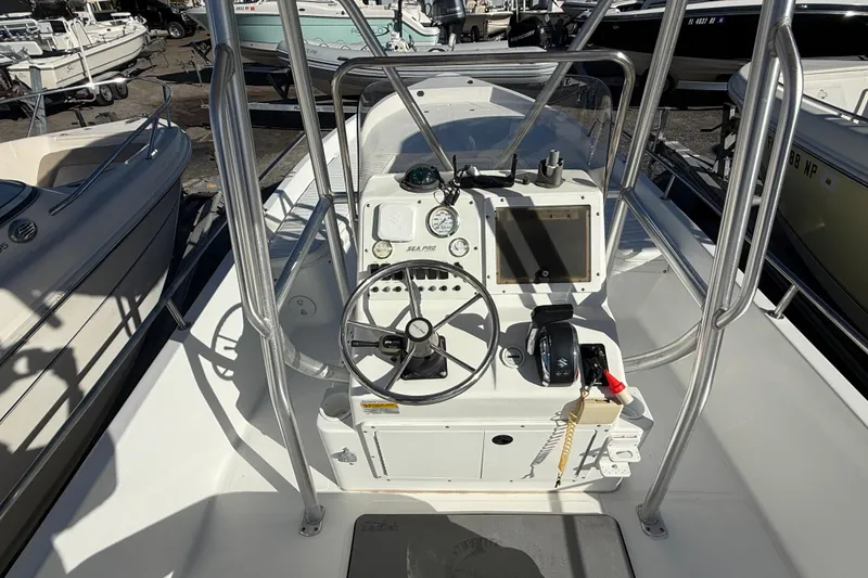 Slide: The Image of 2003 Sea Pro SV2100CC Bay Boat cockpit with steering wheel and controls. - 21