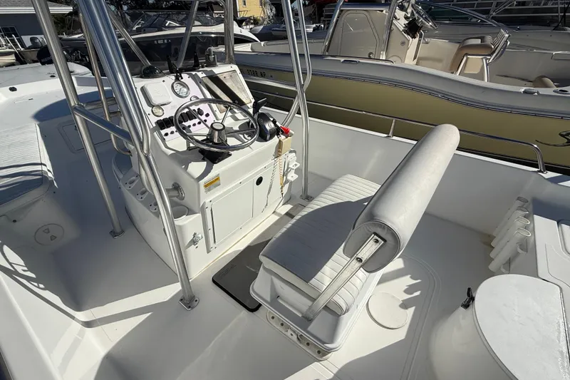 Slide: The Image of 2003 Sea Pro SV2100CC Bay Boat interior with steering console and seating. - 22