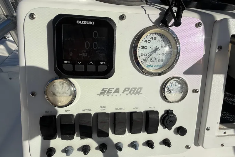 Slide: The Image of Console of a 2003 Sea Pro SV2100CC Bay Boat with Suzuki controls and gauges. - 24
