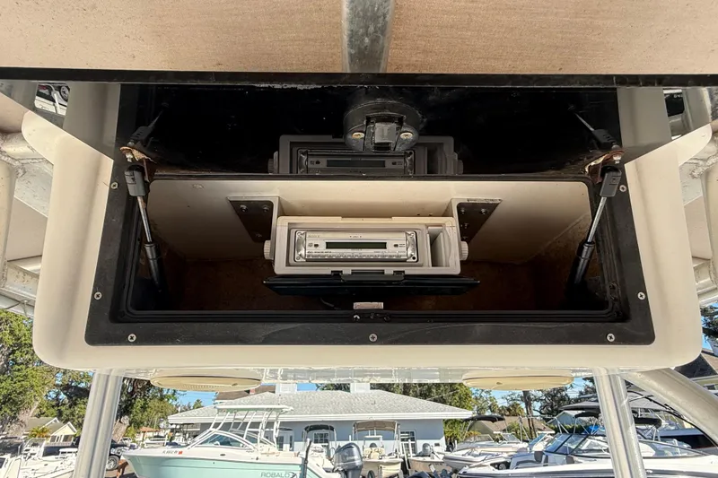 Slide: The Image of 2003 Sea Pro SV2100CC Bay Boat console with stereo system and storage compartment. - 30