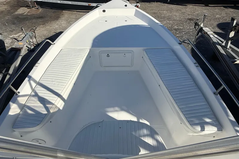 Slide: The Image of 2003 Sea Pro SV2100CC Bay Boat interior with white seating and storage compartments. - 31