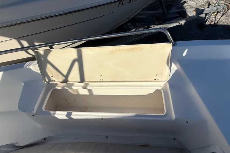 Slide: The Image of 2003 Sea Pro SV2100CC Bay Boat storage compartment with open lid, showing interior space. - 33