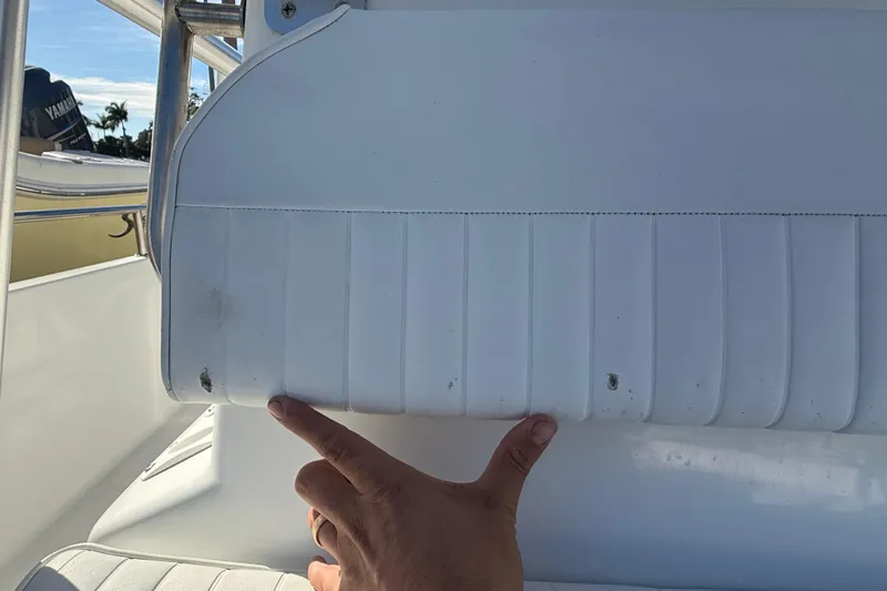 Slide: The Image of White seat on 2003 Sea Pro SV2100CC Bay Boat with visible wear and hand pointing. - 36