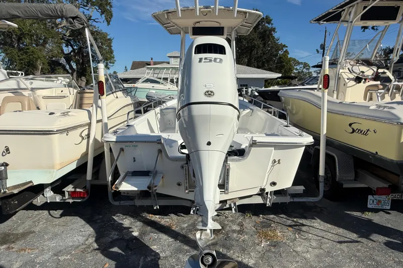 Slide: The Image of 2003 Sea Pro SV2100CC Bay Boat with outboard motor, docked between other boats. - 4