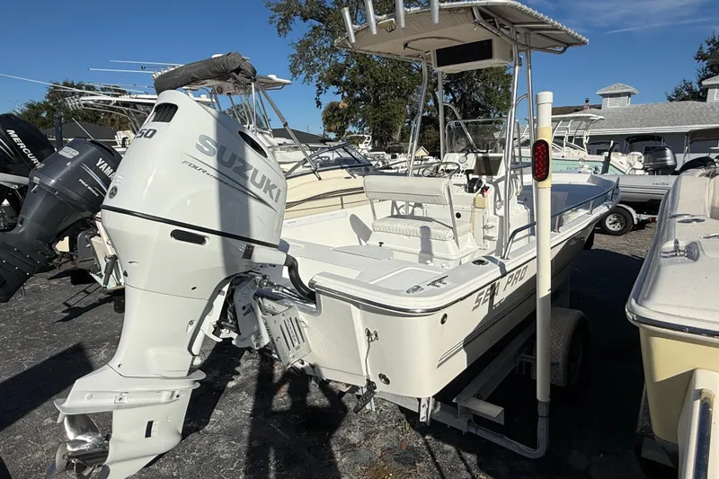 Slide: The Image of 2003 Sea Pro SV2100CC Bay Boat with Suzuki outboard motor, parked on a trailer. - 5