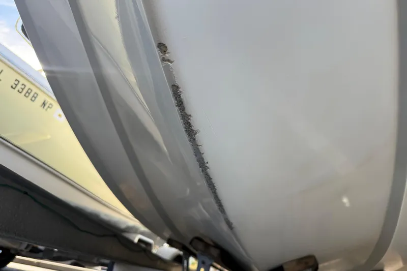 Slide: The Image of Close-up of 2003 Sea Pro SV2100CC Bay Boat hull with visible wear and scratches. - 8