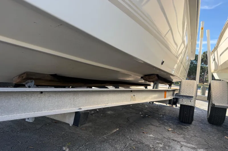 Slide: The Image of 2003 Sea Pro SV2100CC Bay Boat on trailer, close-up view of hull and wheels. - 9