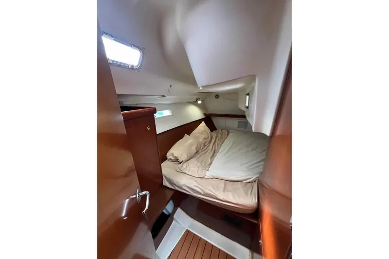Slide: The Image of Beneteau 393 2007 yacht bathroom with skylight, compact design, and modern fixtures. - 10