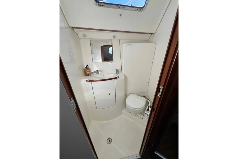 Slide: The Image of Cozy cabin interior of 2007 Beneteau 393 sailboat with wooden finish and comfortable bedding. - 11