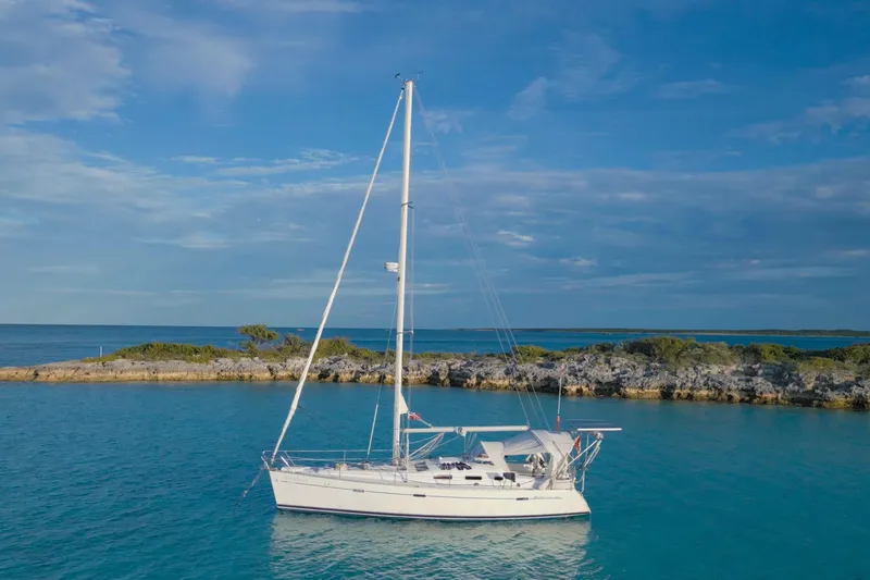 Slide: The Image of Interior of 2007 Beneteau 393 yacht with cozy seating and ambient blue lighting. - 24