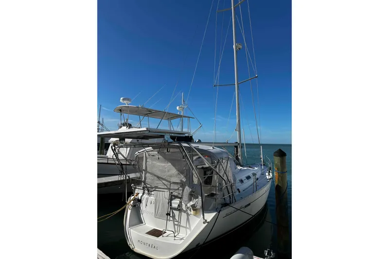Slide: The Image of Sailboat Beneteau 393 (2007) anchored in clear blue water near rocky shoreline. - 29