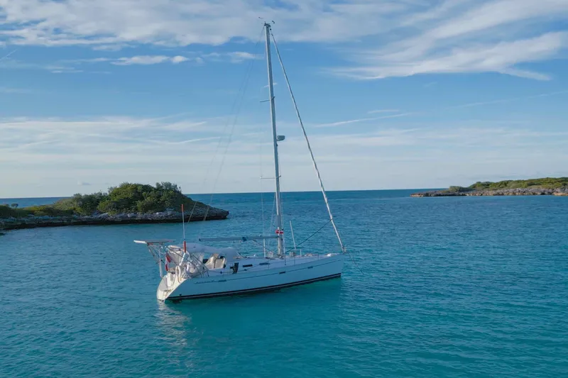 Slide: The Image of Sailboat Beneteau 393, 2007 model, docked under clear blue sky. - 34