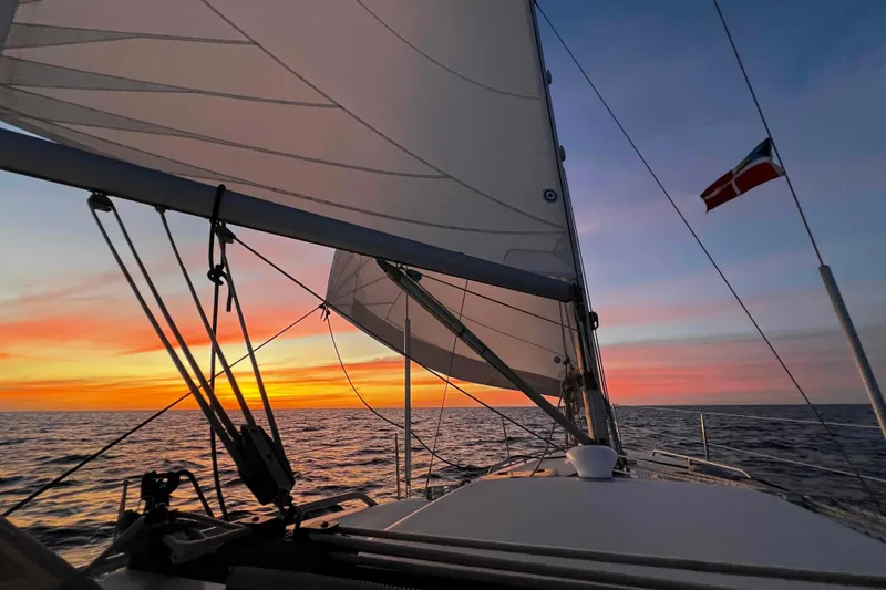 Slide: The Image of Sailing at sunset on a 2007 Beneteau 393 yacht, vibrant sky and ocean view. - 43