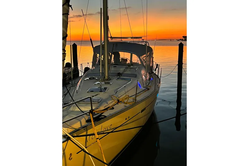 Slide: The Image of Beneteau 393 sailboat docked at sunset, 2007 model, serene waterfront view. - 46