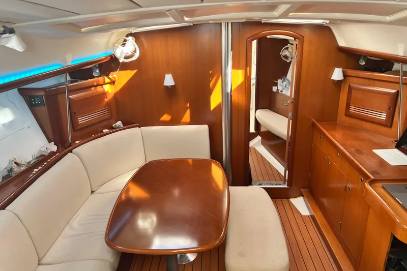 Slide: The Image of 2007 Beneteau 393 yacht kitchen with stove, sink, and wooden cabinetry. - 5