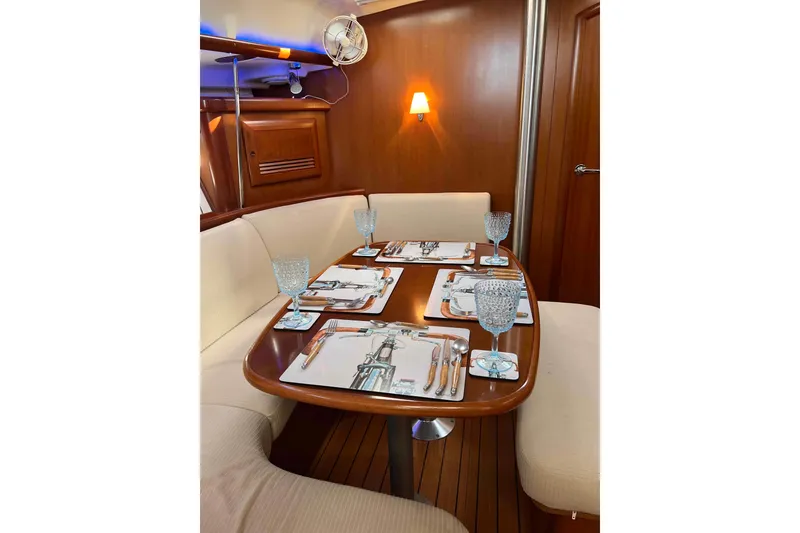 Slide: The Image of Luxurious interior of 2007 Beneteau 393 yacht with dining area and kitchenette. - 7