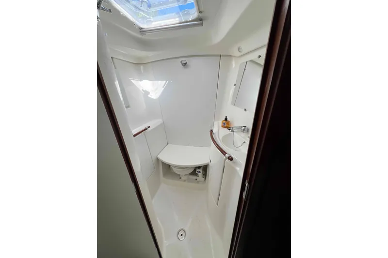 Slide: The Image of Cozy cabin interior of 2007 Beneteau 393 sailboat with wooden finish and comfortable bedding. - 9