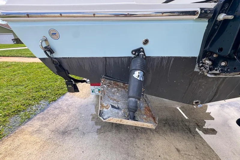 Slide: The Image of 2022 Cobia 220 Center Console boat stern with trim tab and hydraulic system. - 12