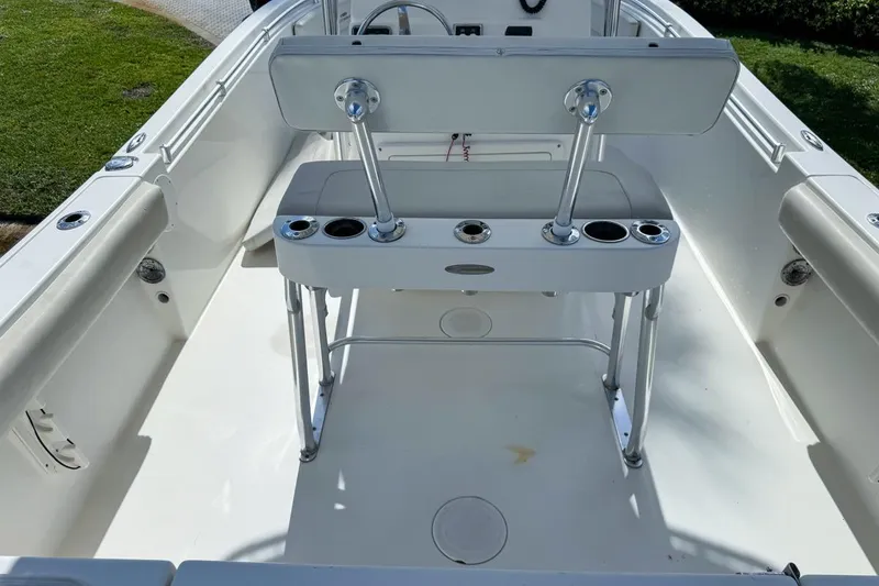 Slide: The Image of 2022 Cobia 220 Center Console boat interior with seating and rod holders. - 19