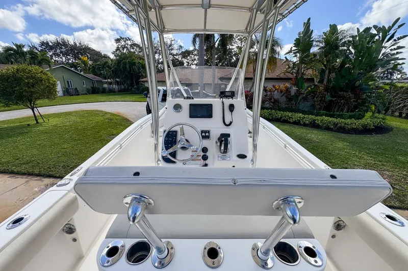 Slide: The Image of 2022 Cobia 220 Center Console boat with steering wheel and control panel. - 27