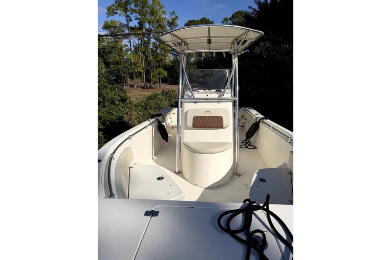 Slide: The Image of 2022 Cobia 220 Center Console boat on trailer, parked outdoors under blue sky. - 3