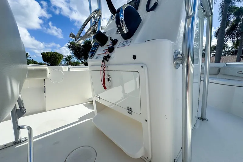 Slide: The Image of 2022 Cobia 220 Center Console boat interior with steering wheel and control panel. - 34