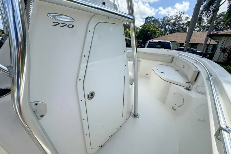 Slide: The Image of 2022 Cobia 220 Center Console boat interior with seating and storage compartments. - 36