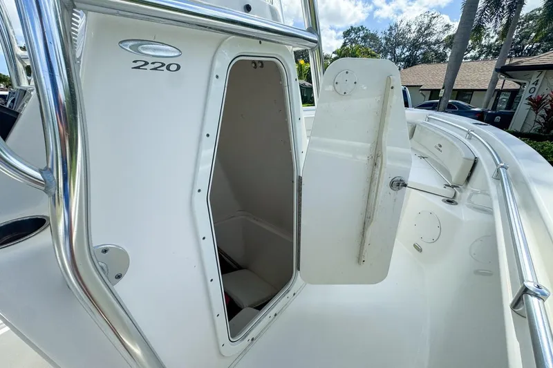 Slide: The Image of 2022 Cobia 220 Center Console boat with open storage compartment. - 37