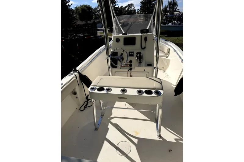 Slide: The Image of 2022 Cobia 220 Center Console boat on trailer in suburban driveway. - 4