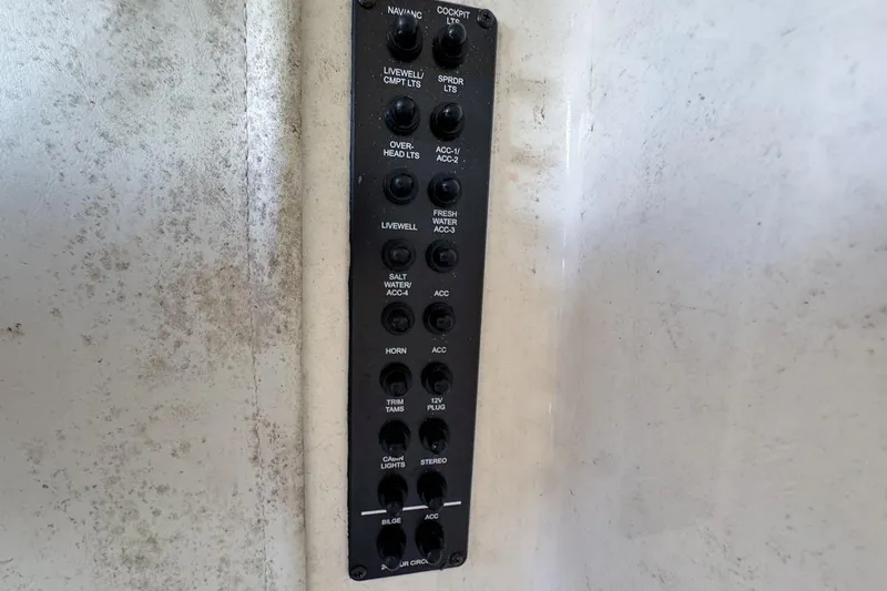 Slide: The Image of Control panel on a 2022 Cobia 220 Center Console boat, featuring various switches. - 40