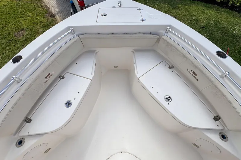Slide: The Image of 2022 Cobia 220 Center Console boat interior with storage compartments and seating. - 41