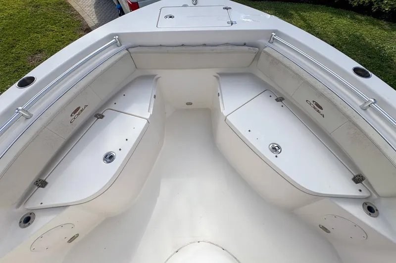 Slide: The Image of 2022 Cobia 220 Center Console boat interior with storage compartments and seating. - 42