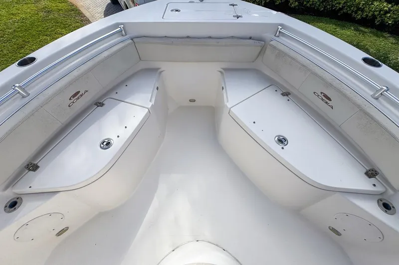 Slide: The Image of 2022 Cobia 220 Center Console boat interior with storage compartments and seating. - 43