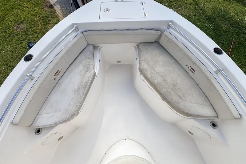 Slide: The Image of 2022 Cobia 220 Center Console boat with cushioned seating and stainless steel railings. - 44