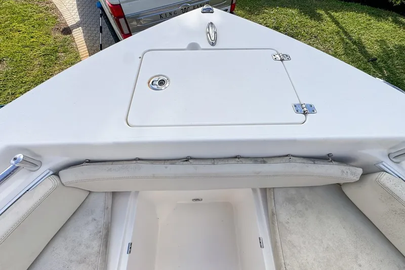 Slide: The Image of 2022 Cobia 220 Center Console boat bow with storage compartment. - 45