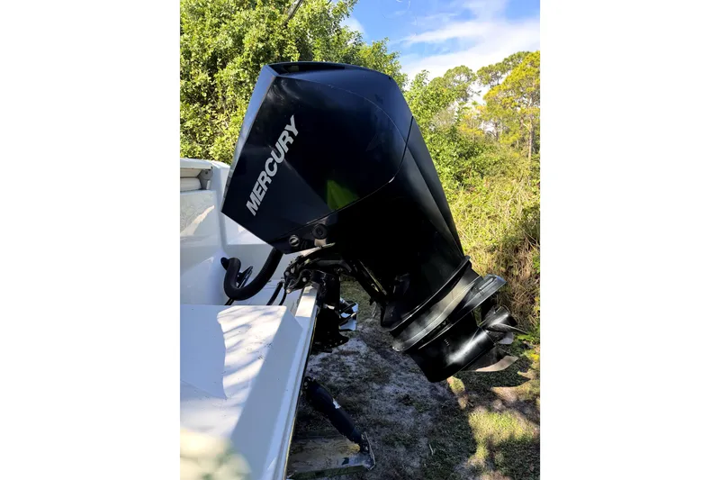 Slide: The Image of 2022 Cobia 220 Center Console boat with outboard motor on driveway. - 5