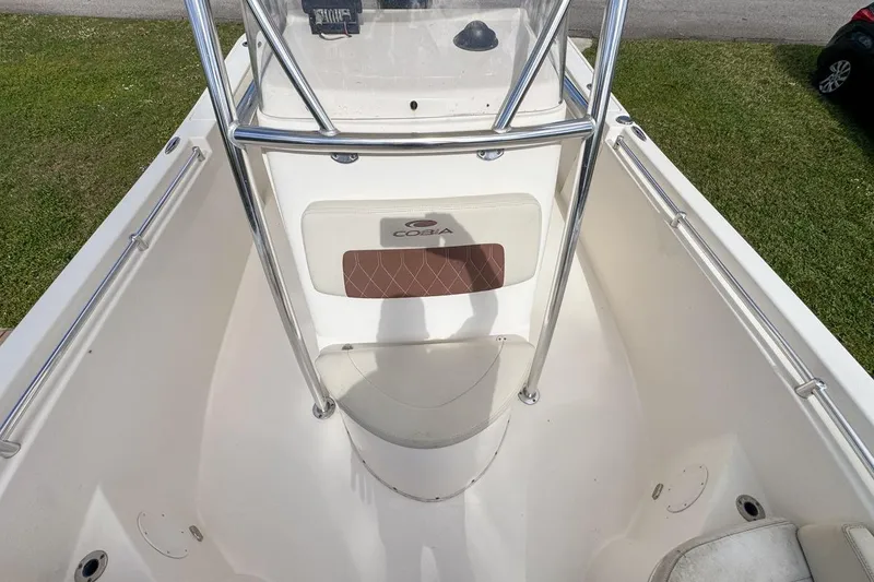 Slide: The Image of 2022 Cobia 220 Center Console boat interior with seating and console view. - 56