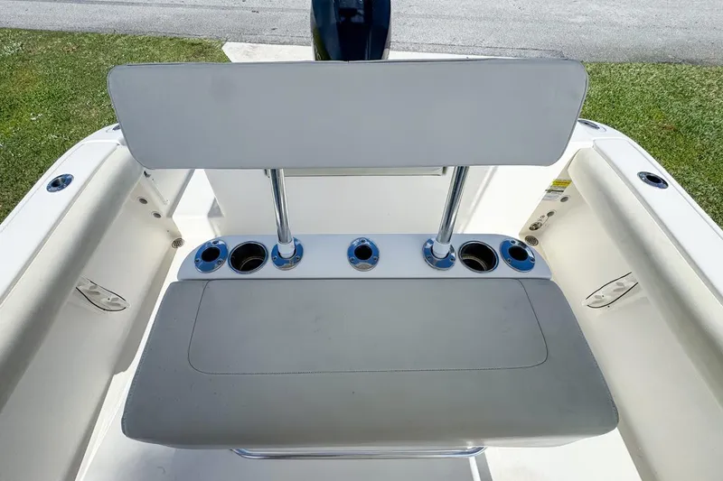 Slide: The Image of 2022 Cobia 220 Center Console boat seating with cup holders, viewed from above. - 69