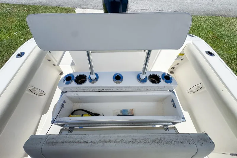 Slide: The Image of 2022 Cobia 220 Center Console boat interior with storage compartment and cup holders. - 70
