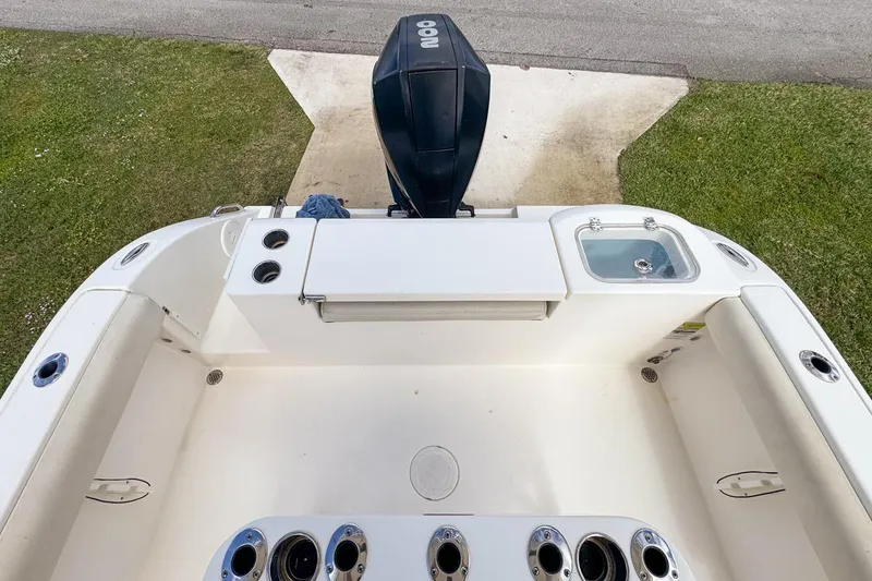Slide: The Image of 2022 Cobia 220 Center Console boat interior with motor and seating area. - 71