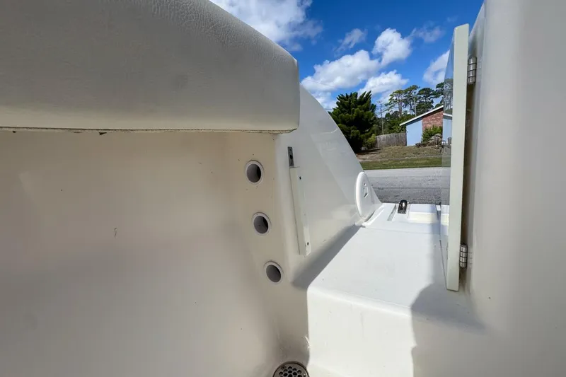Slide: The Image of 2022 Cobia 220 Center Console interior detail with blue sky background. - 84