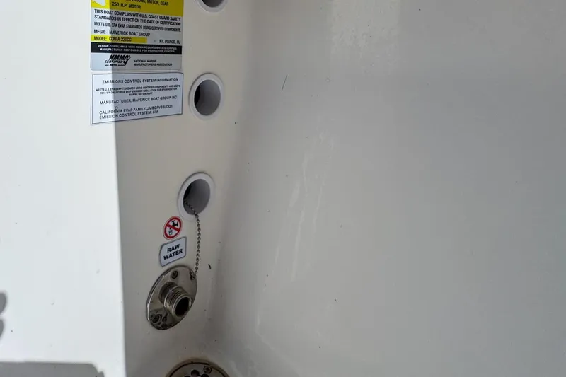 Slide: The Image of 2022 Cobia 220 Center Console boat with safety and emissions labels. - 86